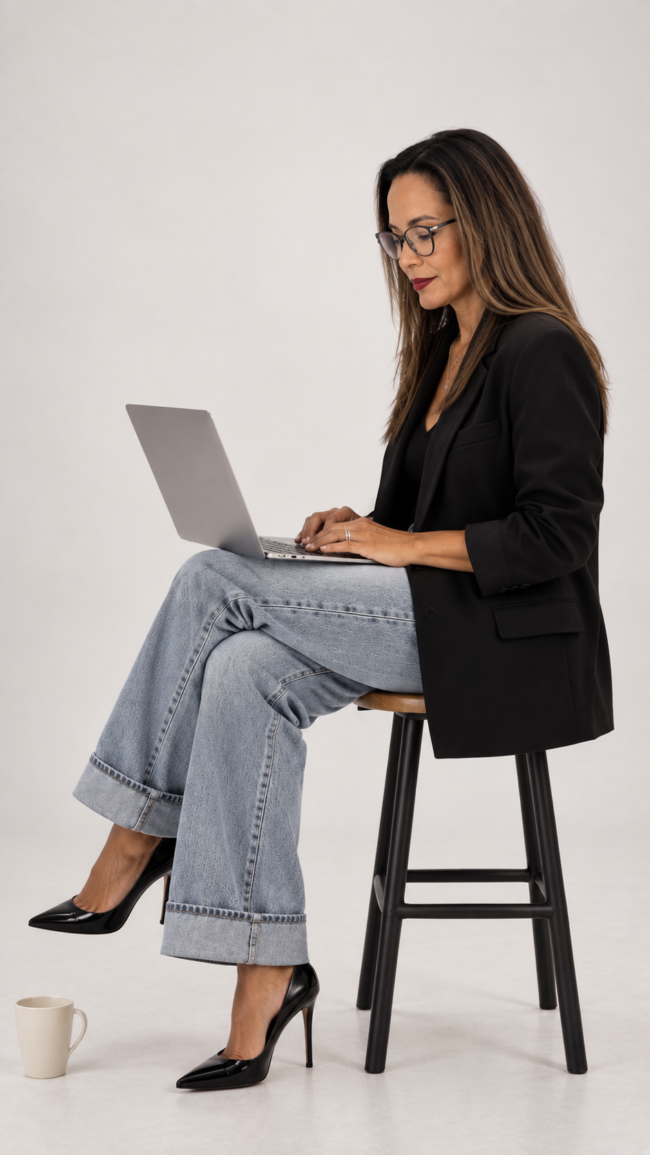 Yohana Hykal, founder of Hykal Homes, working on a laptop